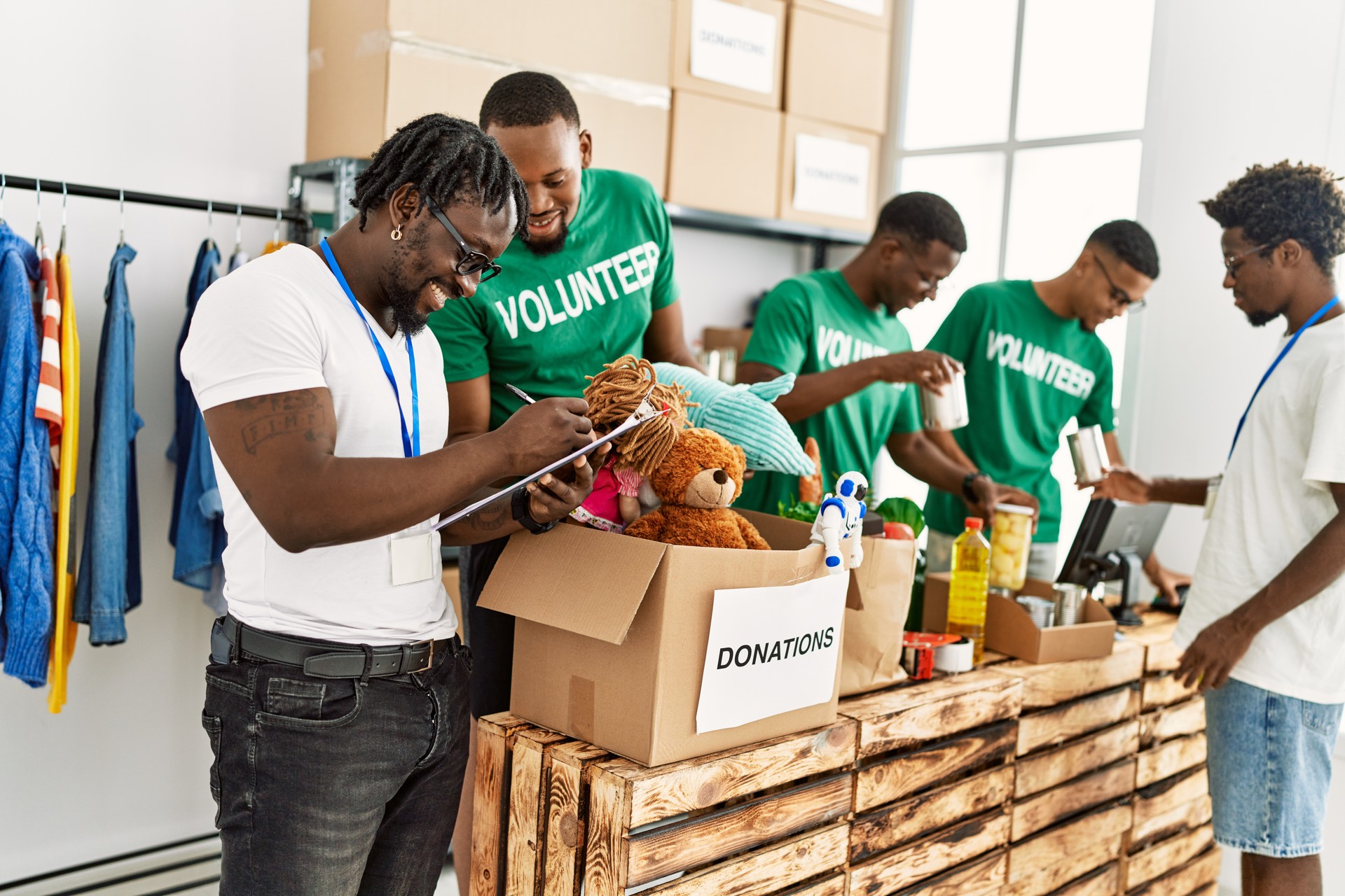 Group of young african american volunteers working at charity center.